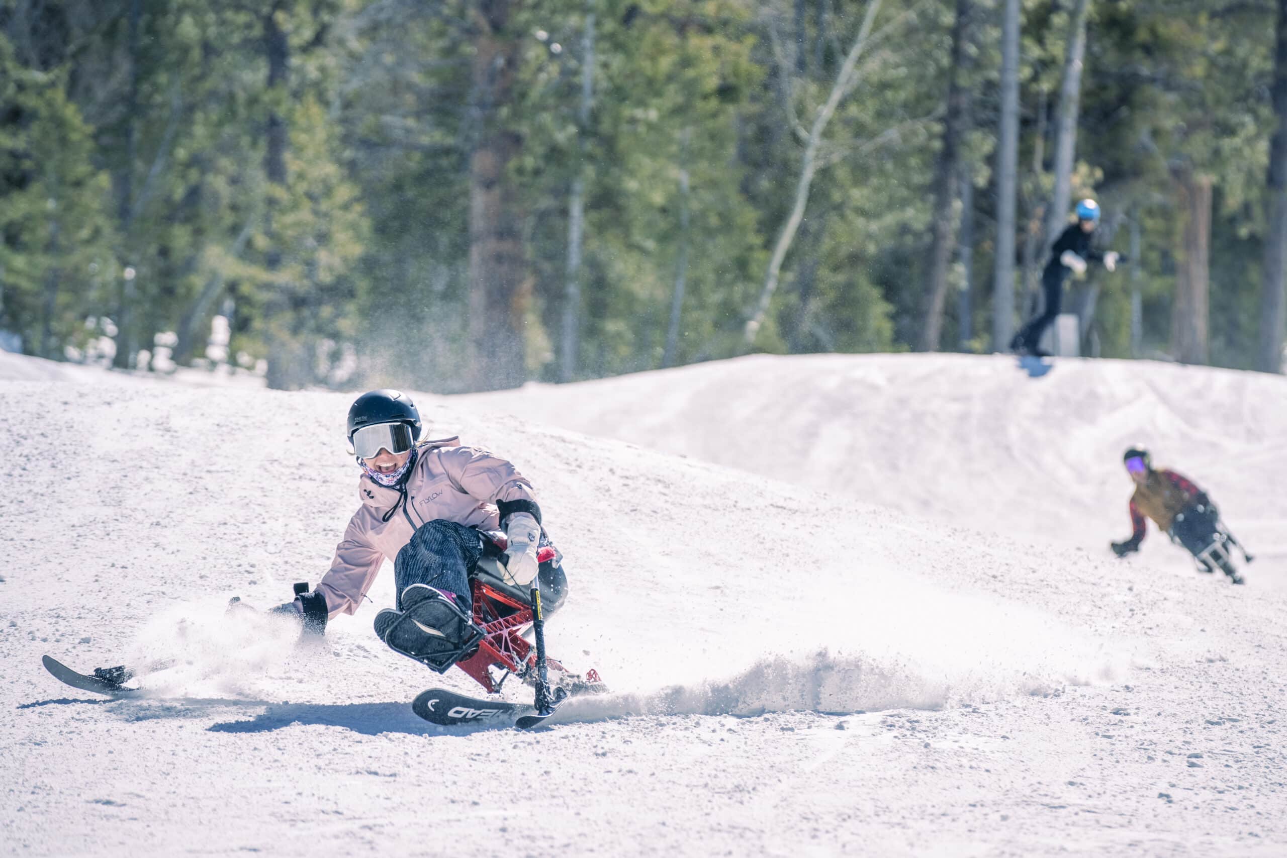 Para-skier enjoys sunny turns at Lee Canyon during Feel Good Friday, with live music and après-ski vibes in a scenic mountain setting.